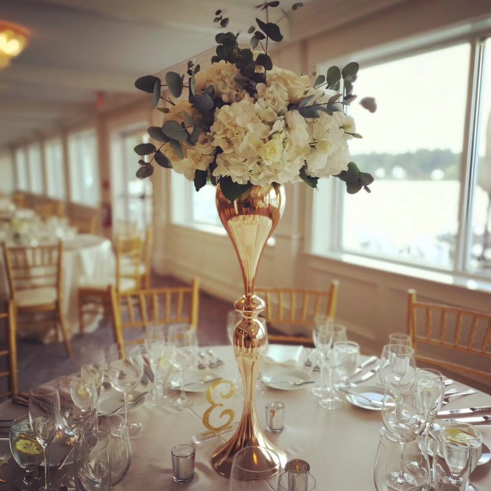 Gold vase with white rose and hydrangea, waterside wedding